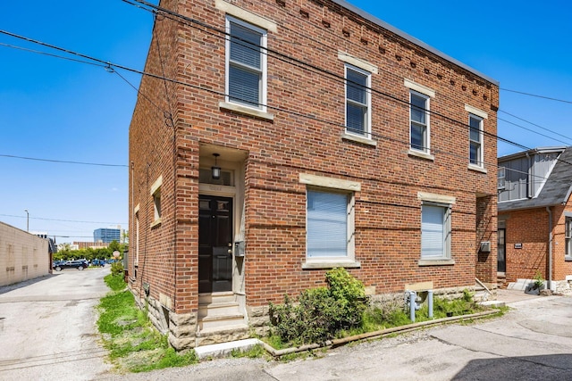 view of front of home featuring entry steps and brick siding