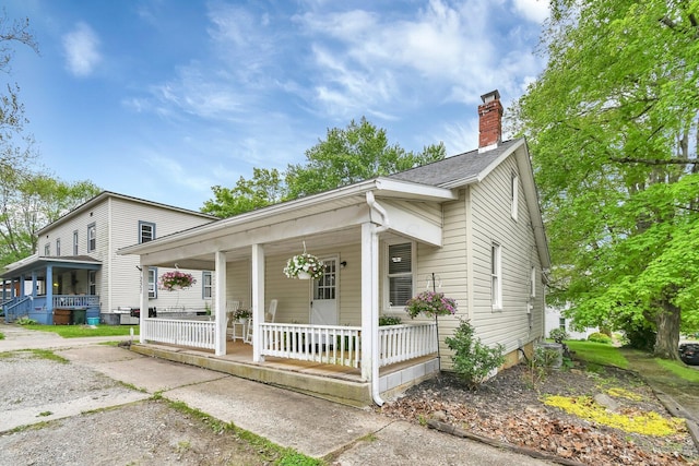 221 W Mulberry St, Baltimore, OH 43105 - view of front of home with covered porch and a chimney