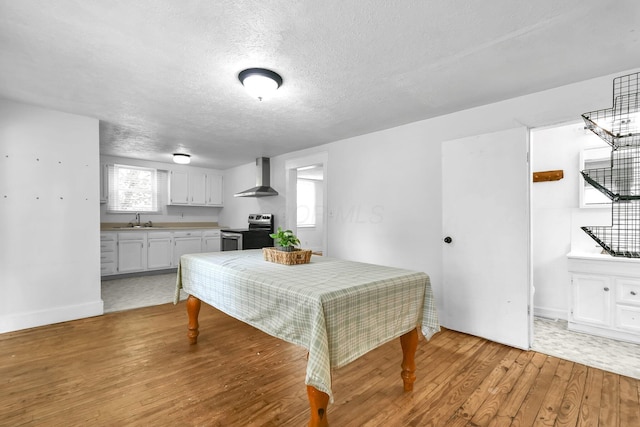 221 W Mulberry St, Baltimore, OH 43105 - dining room featuring light wood-type flooring, a textured ceiling, and baseboards