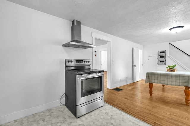 221 W Mulberry St, Baltimore, OH 43105 - kitchen with electric stove, wall chimney exhaust hood, baseboards, and a textured ceiling