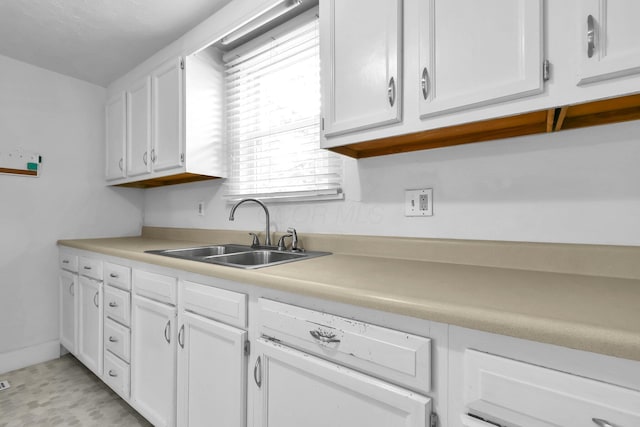 221 W Mulberry St, Baltimore, OH 43105 - kitchen featuring a sink, white cabinets, and light countertops