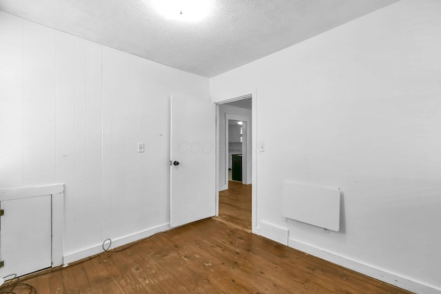 221 W Mulberry St, Baltimore, OH 43105 - unfurnished room featuring hardwood / wood-style floors, a textured ceiling, radiator, and baseboards