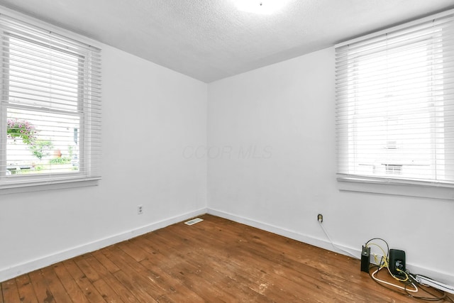 221 W Mulberry St, Baltimore, OH 43105 - unfurnished room featuring wood-type flooring, baseboards, and a textured ceiling