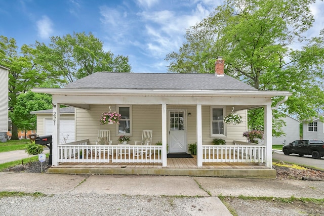 221 W Mulberry St, Baltimore, OH 43105 - bungalow-style home with covered porch, roof with shingles, and a chimney