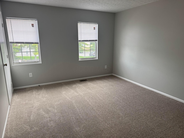 5076 Dalmeny Ct, Columbus, OH 43220 - carpeted empty room featuring a textured ceiling and baseboards