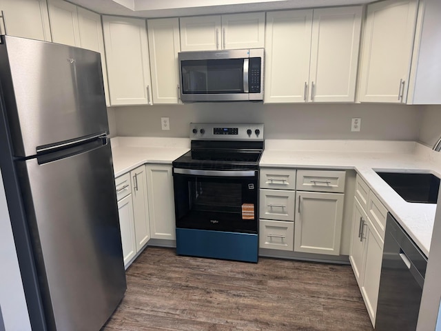 5076 Dalmeny Ct, Columbus, OH 43220 - kitchen with appliances with stainless steel finishes, dark wood-style floors, a sink, and white cabinets