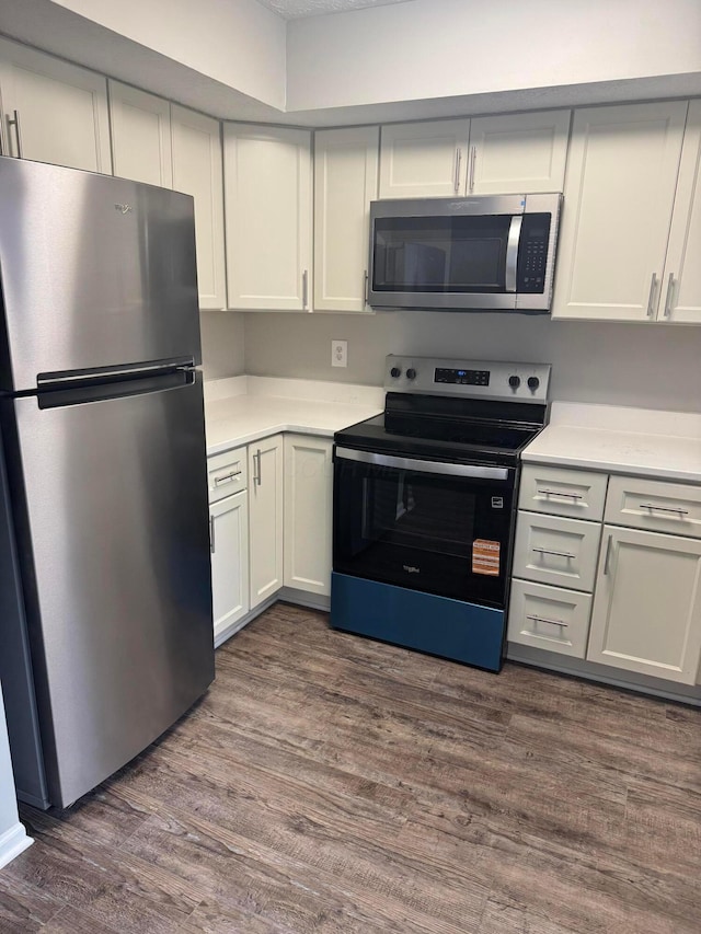 5076 Dalmeny Ct, Columbus, OH 43220 - kitchen featuring appliances with stainless steel finishes, light countertops, dark wood-type flooring, and white cabinets