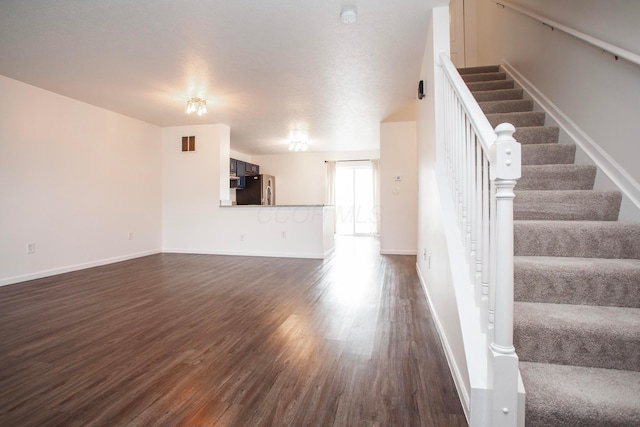 960 Hartford Village Blvd, Columbus, OH 43228 - unfurnished living room featuring dark wood-style flooring, stairway, and baseboards