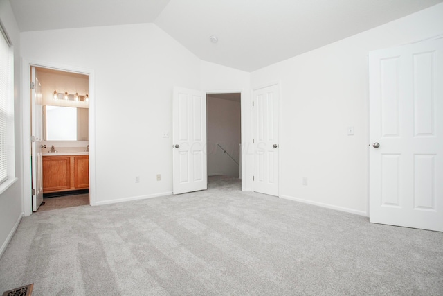 960 Hartford Village Blvd, Columbus, OH 43228 - unfurnished bedroom with vaulted ceiling, light colored carpet, baseboards, ensuite bath, and a sink