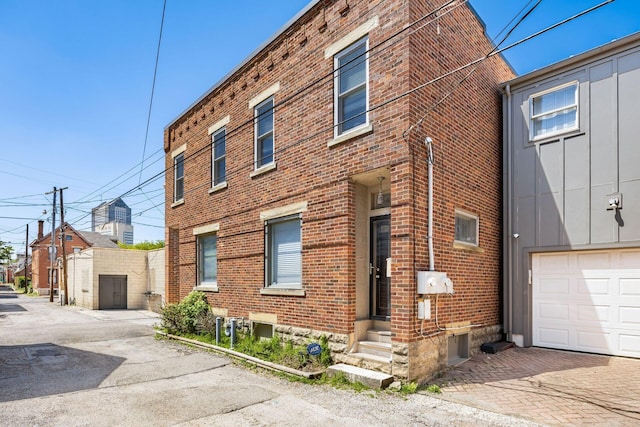 204-206 E Blenkner St, Columbus, OH 43206 - view of property exterior featuring brick siding and an attached garage