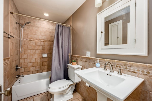 204-206 E Blenkner St, Columbus, OH 43206 - full bathroom featuring tile walls, toilet, shower / bath combo with shower curtain, tile patterned floors, and a wainscoted wall