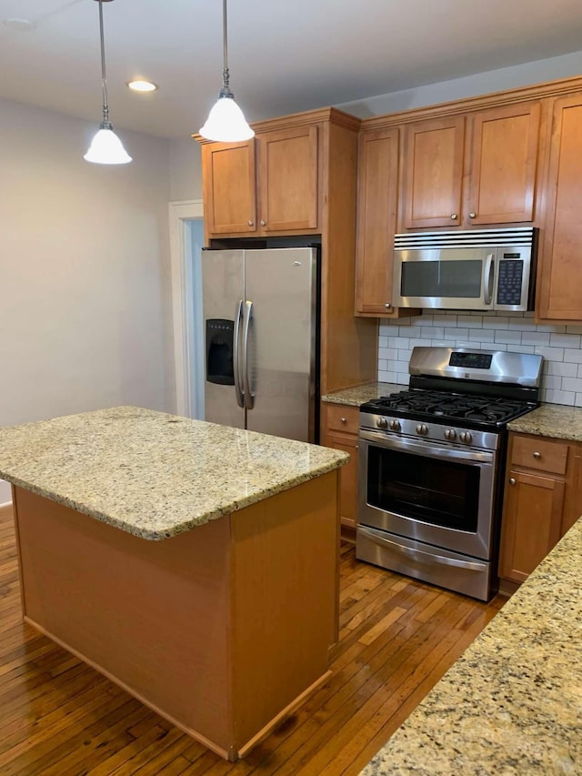 204-206 E Blenkner St, Columbus, OH 43206 - kitchen featuring stainless steel appliances, hardwood / wood-style flooring, a center island, decorative backsplash, and recessed lighting