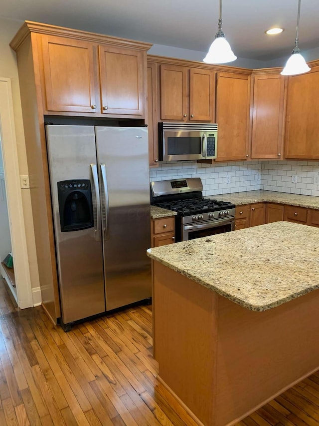 204-206 E Blenkner St, Columbus, OH 43206 - kitchen featuring stainless steel appliances, hardwood / wood-style flooring, tasteful backsplash, brown cabinets, and recessed lighting