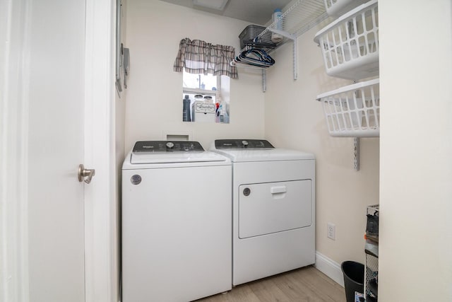 2806 Claude Dr, Columbus, OH 43207 - laundry area with independent washer and dryer, light wood finished floors, and baseboards