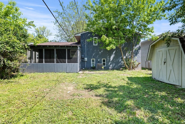 4187 Medway Ave, Columbus, OH 43213 - view of green lawn featuring a sunroom, a storage shed, an outdoor structure, and central AC unit