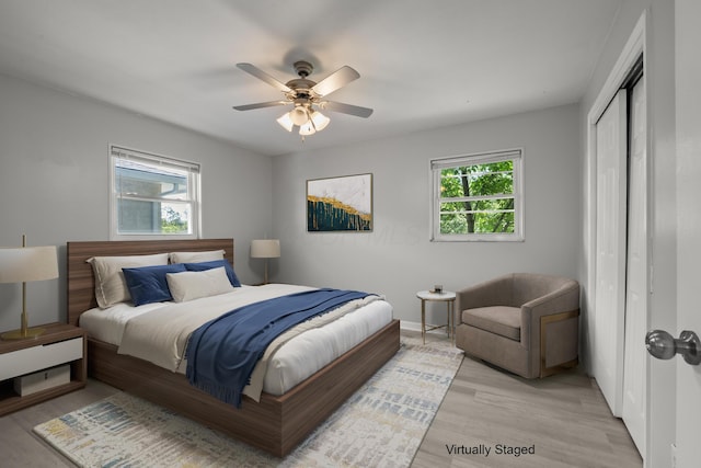 4187 Medway Ave, Columbus, OH 43213 - bedroom featuring light wood-style flooring, a closet, a ceiling fan, and baseboards