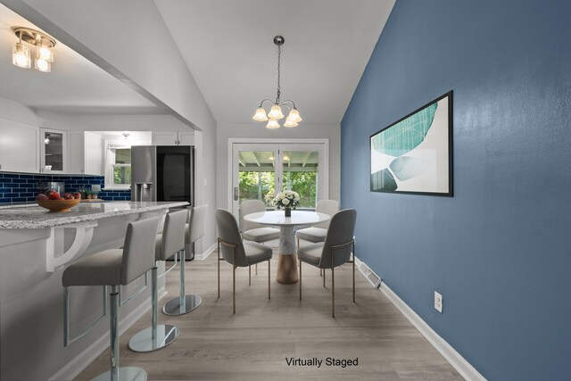 4187 Medway Ave, Columbus, OH 43213 - dining room with a chandelier, light wood-style flooring, lofted ceiling, and baseboards