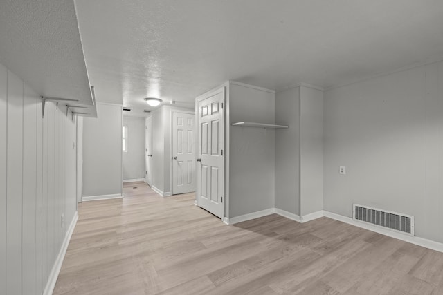 4187 Medway Ave, Columbus, OH 43213 - basement with light wood-style flooring, baseboards, and a textured ceiling