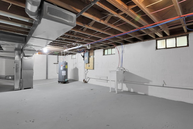 below grade area featuring electric water heater, heating unit, and electric panel