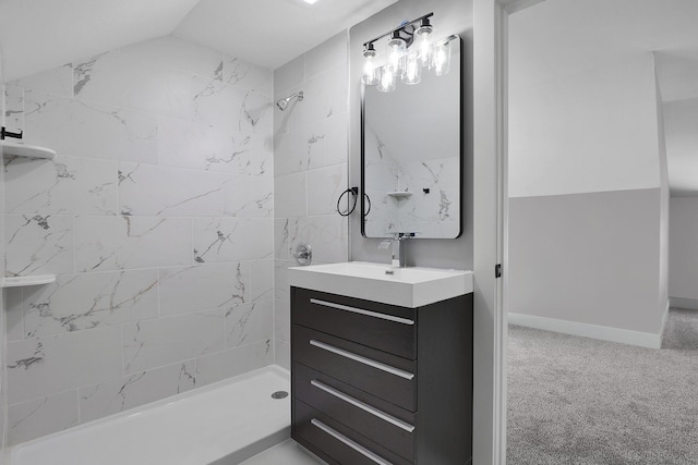 bathroom featuring a tile shower and vanity