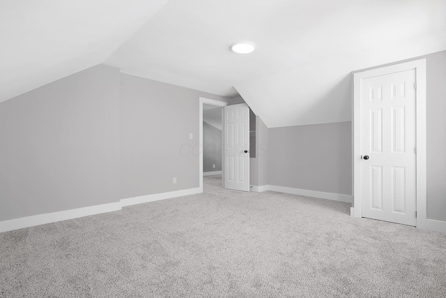 bonus room with vaulted ceiling, carpet, and baseboards