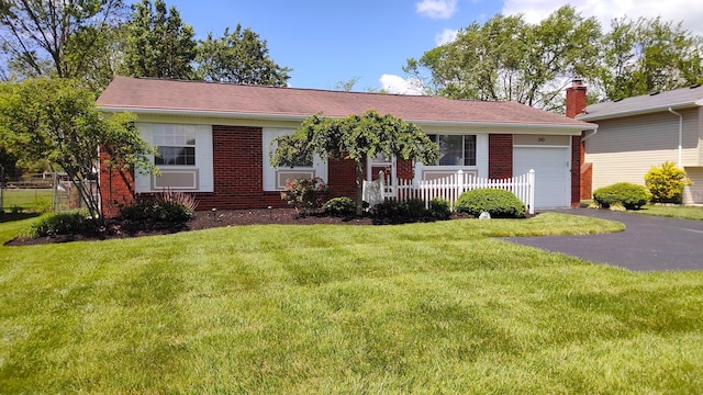 245 Hubbard Rd, Galloway, OH 43119 - ranch-style home with brick siding, an attached garage, and asphalt driveway