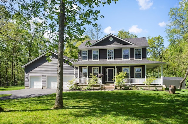 7353 Selma Pike, South Charleston, OH 45368 - colonial-style house with asphalt driveway, covered porch, a front yard, and an attached garage