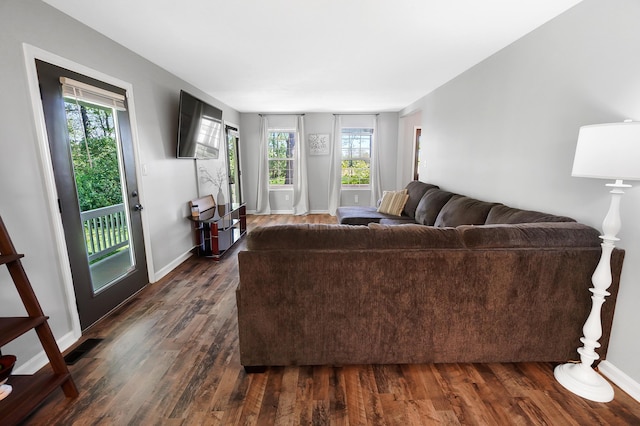 7353 Selma Pike, South Charleston, OH 45368 - living area featuring dark wood finished floors, plenty of natural light, and baseboards