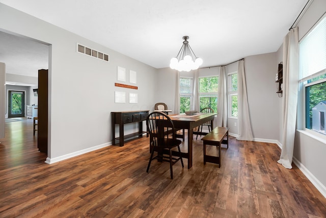7353 Selma Pike, South Charleston, OH 45368 - dining space featuring dark wood finished floors, healthy amount of natural light, and a chandelier