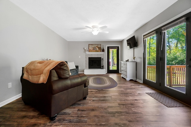 7353 Selma Pike, South Charleston, OH 45368 - living room featuring ceiling fan, dark wood finished floors, baseboards, and a fireplace