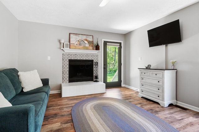 7353 Selma Pike, South Charleston, OH 45368 - living room featuring wood finished floors, baseboards, and a tiled fireplace