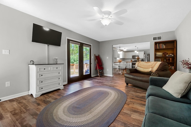 7353 Selma Pike, South Charleston, OH 45368 - living room featuring ceiling fan, baseboards, dark wood finished floors, and a chandelier