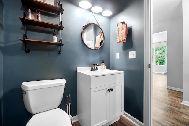 7353 Selma Pike, South Charleston, OH 45368 - bathroom with wood finished floors, toilet, baseboards, and vanity