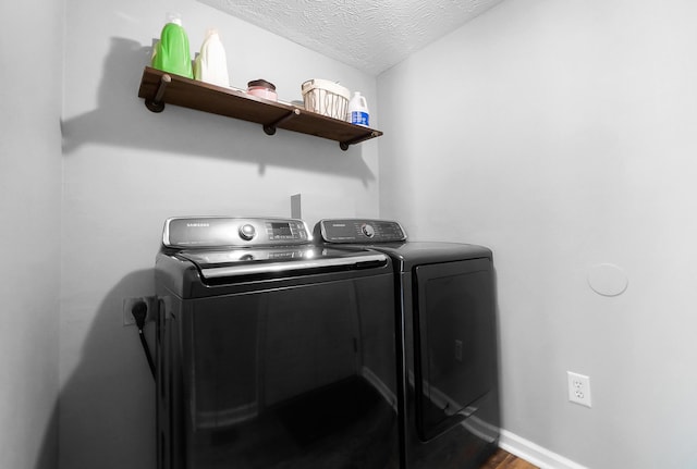 7353 Selma Pike, South Charleston, OH 45368 - laundry room with washer and dryer, a textured ceiling, baseboards, and dark wood finished floors