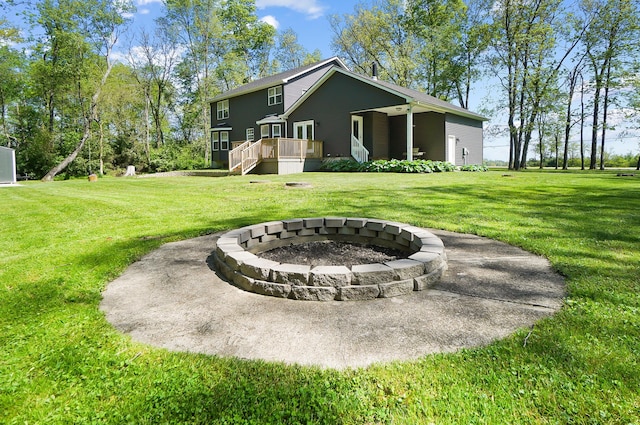 7353 Selma Pike, South Charleston, OH 45368 - view of grassy yard featuring an outdoor fire pit, a deck, and stairway
