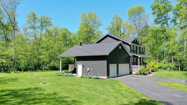 7353 Selma Pike, South Charleston, OH 45368 - view of side of property with asphalt driveway, a lawn, and a garage