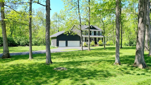 7353 Selma Pike, South Charleston, OH 45368 - view of front of property with driveway, a garage, a front yard, and covered porch