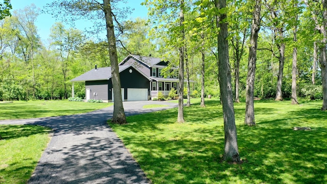 7353 Selma Pike, South Charleston, OH 45368 - view of front of property featuring asphalt driveway, a front yard, and a garage