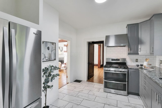 255 E Kelso Rd, Columbus, OH 43202 - kitchen with stainless steel appliances, wall chimney range hood, gray cabinets, and light marble finish floors