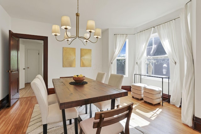 255 E Kelso Rd, Columbus, OH 43202 - dining area with a chandelier, light wood-style flooring, and baseboards