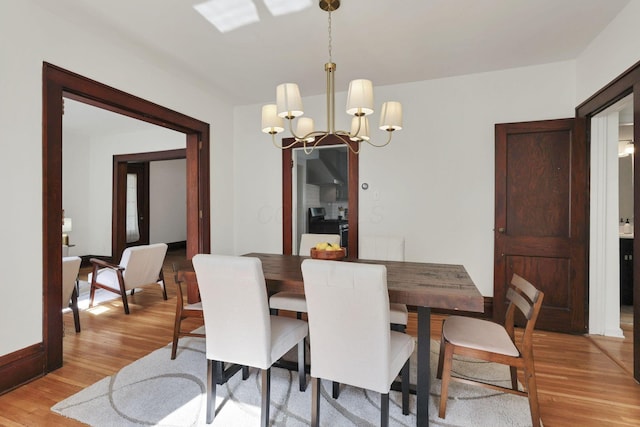255 E Kelso Rd, Columbus, OH 43202 - dining space featuring a chandelier, light wood-style floors, and baseboards
