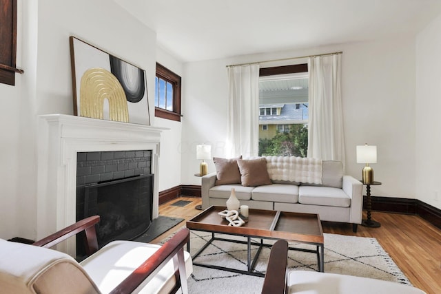255 E Kelso Rd, Columbus, OH 43202 - living area featuring wood finished floors, baseboards, and a fireplace with raised hearth