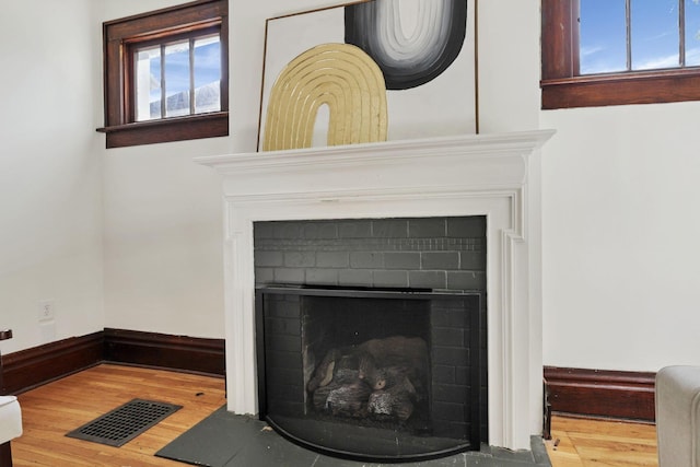 255 E Kelso Rd, Columbus, OH 43202 - detailed view of wood finished floors, a fireplace with flush hearth, and baseboards