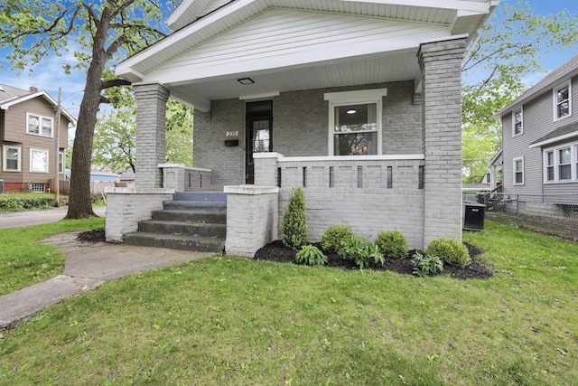 255 E Kelso Rd, Columbus, OH 43202 - view of front of house with brick siding, central AC, and covered porch