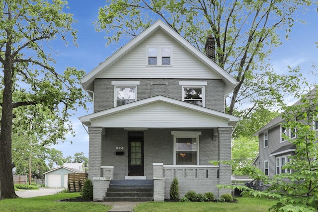 255 E Kelso Rd, Columbus, OH 43202 - american foursquare style home with brick siding, a porch, a chimney, a garage, and a front yard
