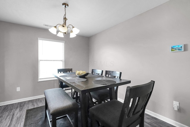 5617 Branchville Dr, Canal Winchester, OH 43110 - dining area featuring a chandelier, dark wood-style flooring, and baseboards