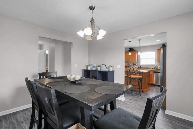 5617 Branchville Dr, Canal Winchester, OH 43110 - dining space with a chandelier, dark wood finished floors, and baseboards