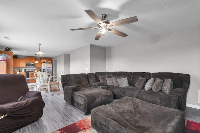 5617 Branchville Dr, Canal Winchester, OH 43110 - living room featuring light wood-style floors, a ceiling fan, and baseboards