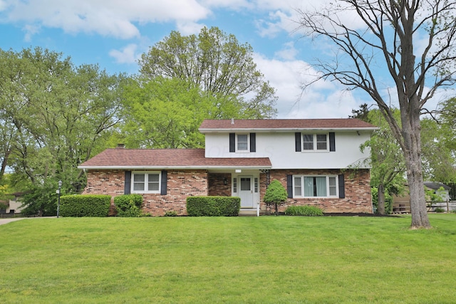 6070 Barberry Holw, Columbus, OH 43213 - traditional-style home with brick siding, a front yard, stucco siding, and a chimney