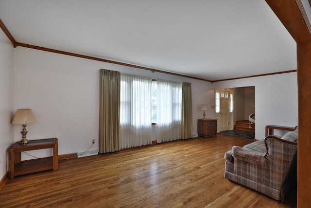 6070 Barberry Holw, Columbus, OH 43213 - unfurnished living room featuring ornamental molding, wood finished floors, and baseboards